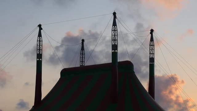 Beautiful silhouette big top circus on the background of floating clouds at sunset