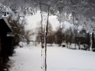 icicles in winter, and in the background landscape, macro