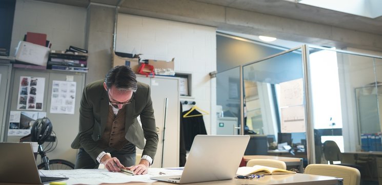 Business executive working on blueprint