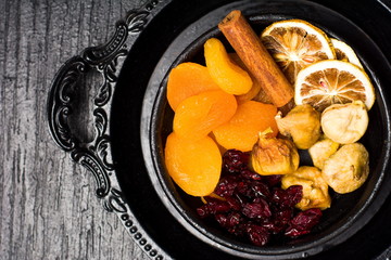 Dried fruit slices on a dark plate
