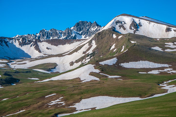The snowy mountains in summer. June.