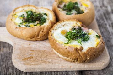 Scrambled eggs with bacon in a bun.