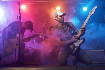 Fototapeta na wymiar Guitarist and bass player perform on stage.