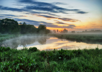 spring morning. a picturesque foggy dawn by the river. Sun rays