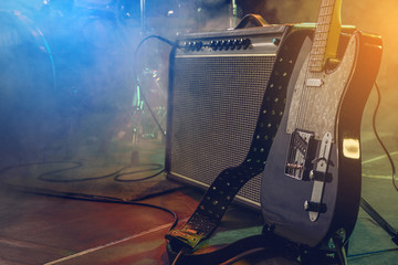 Guitar and combo on stage.