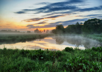 spring morning. a picturesque foggy dawn by the river. Sun rays