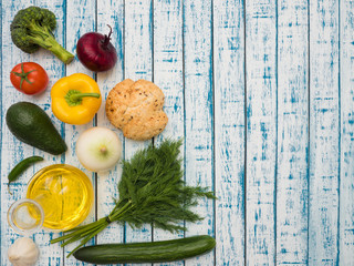 Fresh vegetables, decanter with sunflower oil and bread on the table