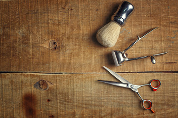Vintage tools of barber shop on wooden background