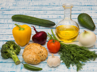 Fresh vegetables, decanter with sunflower oil and bread on the table