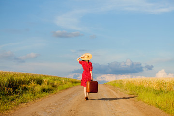 girl with bag walking on road at countryside