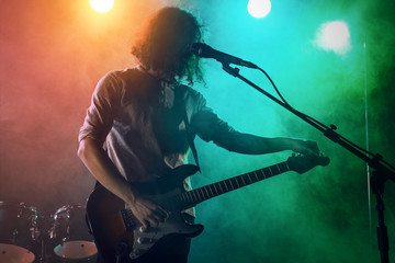 The guitarist performs on stage.