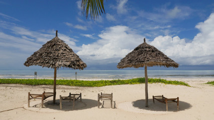 Bamboo huts on tropical island Zanzibar with turquoise sea
