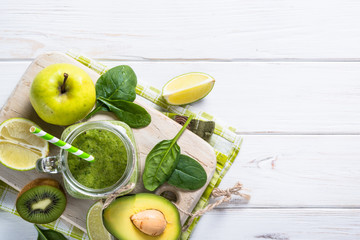 Green food background. Fresh fruit and smoothie on the table.