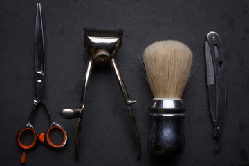 Vintage tools of barber shop on black background