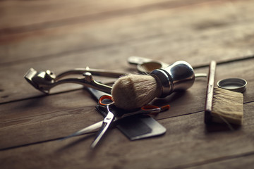 Vintage tools of barber shop on wooden background