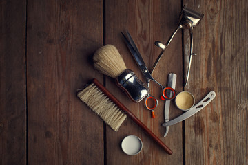 Vintage tools of barber shop on wooden background