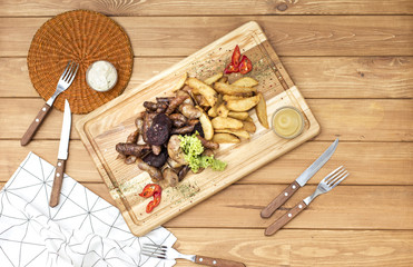 Sausages and potatos grilled on the board