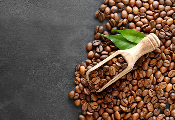 Coffee beans and an  wooden scoop
