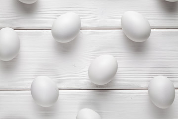 White easter eggs on wooden table