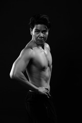 Obraz na płótnie Canvas Portrait of an athletic Asian Man, black and white photo