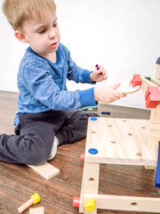 the little boy himself assembles a stool