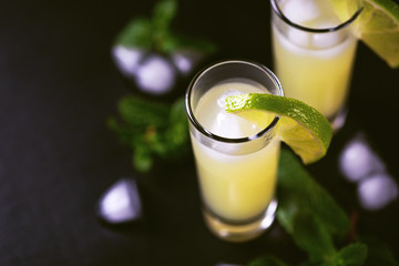 Italian lemon lime liqueur limoncello with ice and mint