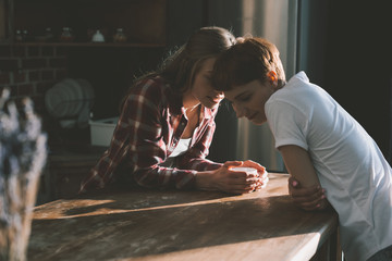 young lesbian couple spending time together on kitchen in morning