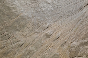 Figure in the form of curved lines in the sand on the beach, make waves