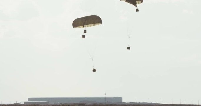 C-130 transport airplane droping cargo during combat