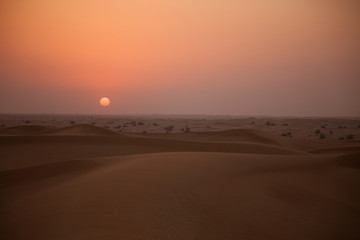 Fototapeta na wymiar Dunes right at sunset in a desert near Dubai