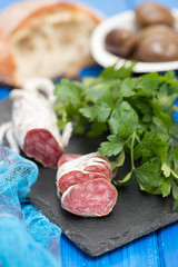 Traditional Spanish sausage Fuet on black ceramic background