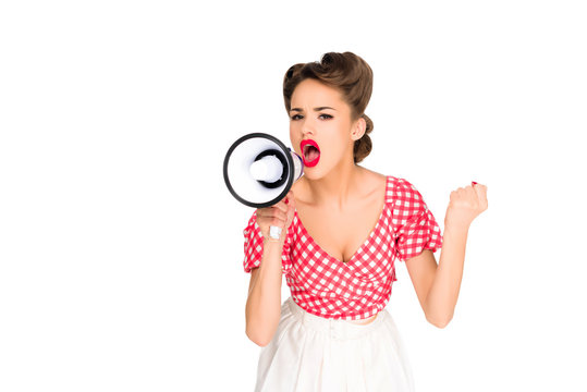 portrait of fashionable young woman in pin up style clothing screaming into loudspeaker isolated on white