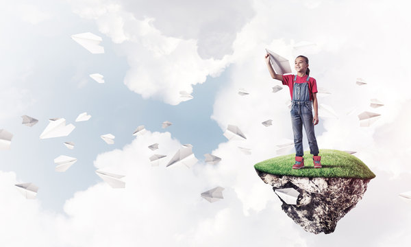 Concept of careless happy childhood with girl playing with airpl