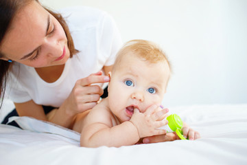 Mother looking into baby's ear