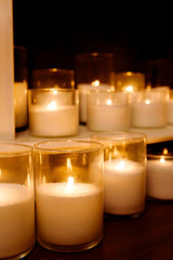 Decorative fireplace with candles. A warm picture of burning candles by the fireplace in the dark.