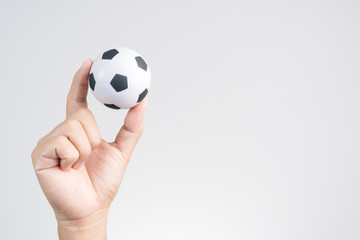 Obraz premium Hand holding small soccer ball or football