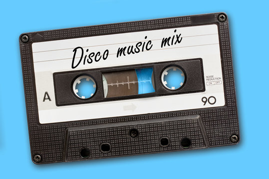 Disco music mix written on vintage audio cassette tape, blue background
