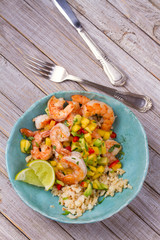 Shrimps with mango avocado and red pepper salsa on cauliflower rice