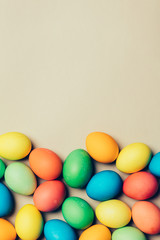 Bunch of dyed eggs laying on the floor.