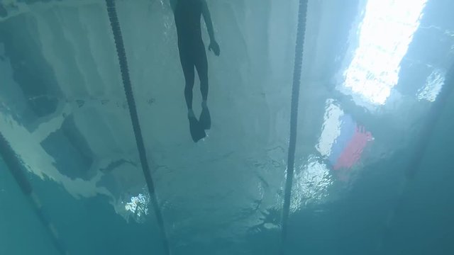 swimmer athlete dives into the water. underwater video shooting in the pool