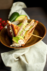 Top view of Healthy Sandwich toast with lettuce, ham, cheese and tomato on a wooden background