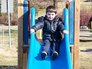 Fototapeta na wymiar child in the playground slide