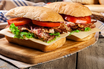 Ciabatta sandwich with smoked bacon, cheese and tomato