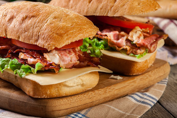 Ciabatta sandwich with smoked bacon, cheese and tomato