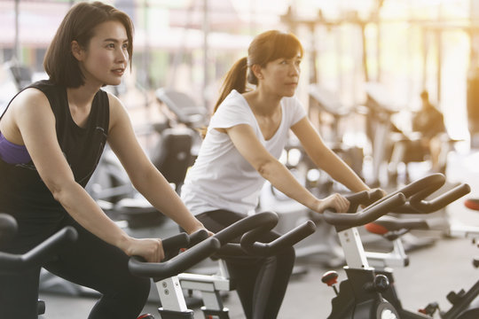 Close-up footage of a women working out in gym on the exercise bike, young woman cycling in the gym. female exercising in fitness gym for good health.