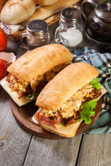 Ciabatta sandwich with smoked bacon and eggs