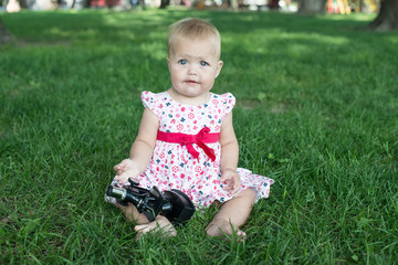 student little girl with microscope - working outside in nature