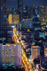 Top View of City Road and Bangkok Cityscape with Car Traffic Light Trial at Night Time, Thailand. Portrait Orientation.