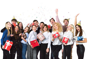 Obraz premium Cheerful joyful young people friends standing and celebrating together over white background.