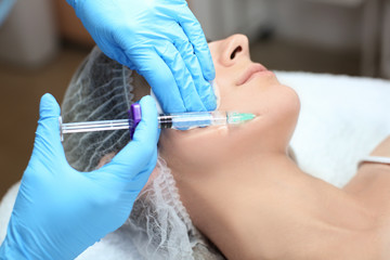 Beautician making injection in woman's face, closeup. Biorevitalization procedure